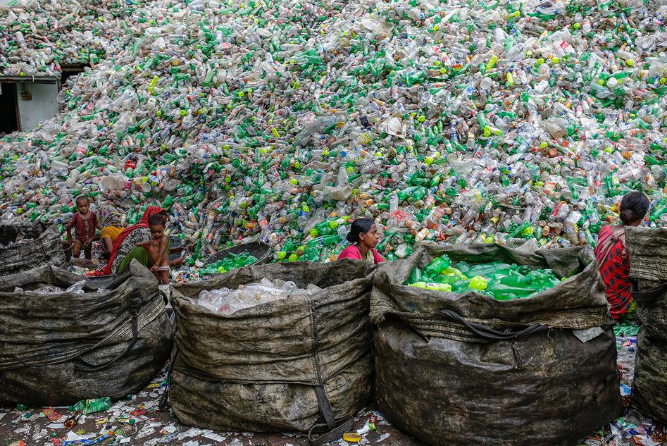 Image of Female workers sorting plastic bottles for recycling in Dhaka. The projected GhG emissions of plastic production by 2030 is 1.34 billion tons/year - equivalent to the emissions of 300 new 500MW coal-fired power plants.