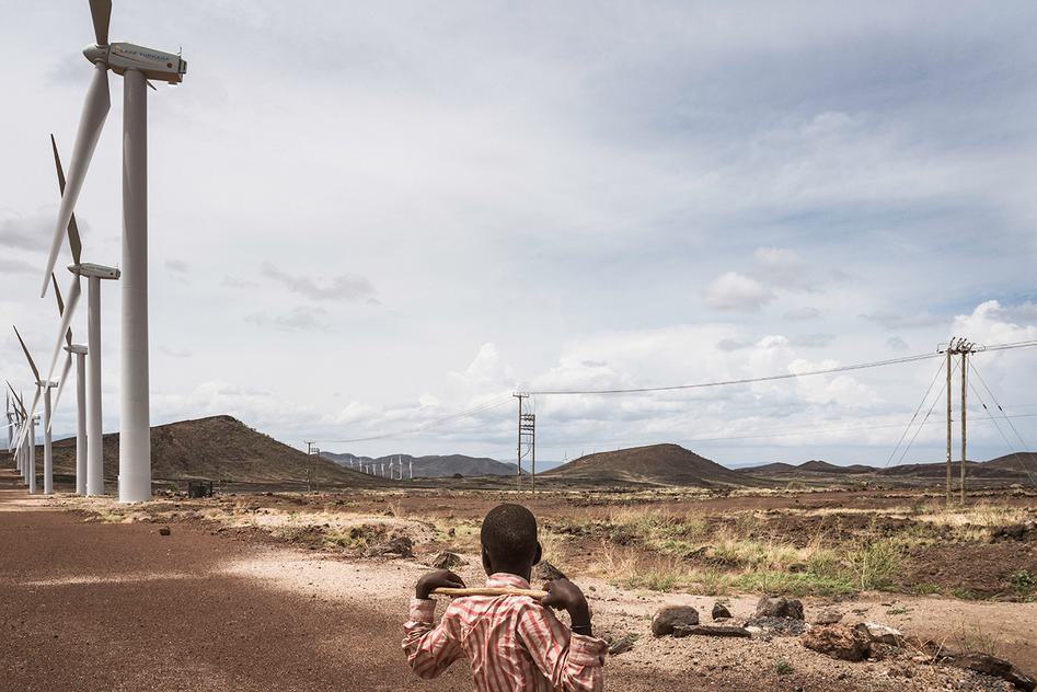 Photo of a boy looking on to Lake Turkana Wind Power’s 365 turbines, in land also used by the local nomadic population for settlement, grazing of livestock, and access to water points.