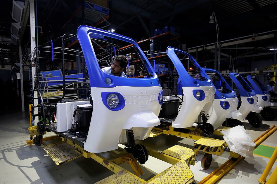 An employee on the assembly line of the Mahindra Treo e-auto factory in Bangalore, India.