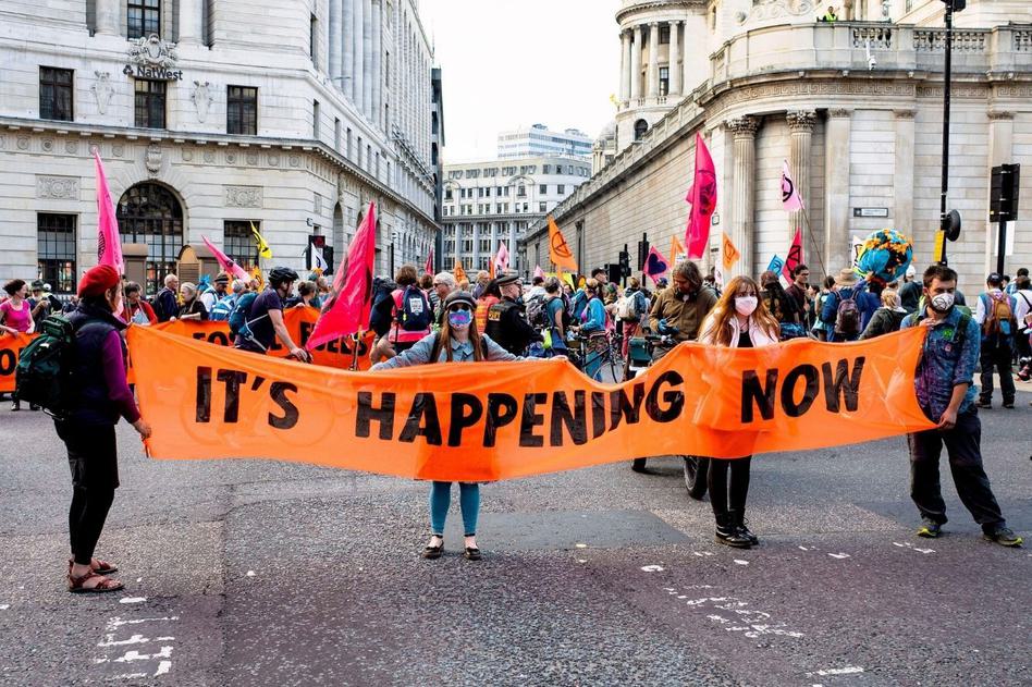 Photo of Extinction Rebellion protesters outside the Bank of England, part of their 2021 "Blood Money March" in London.
